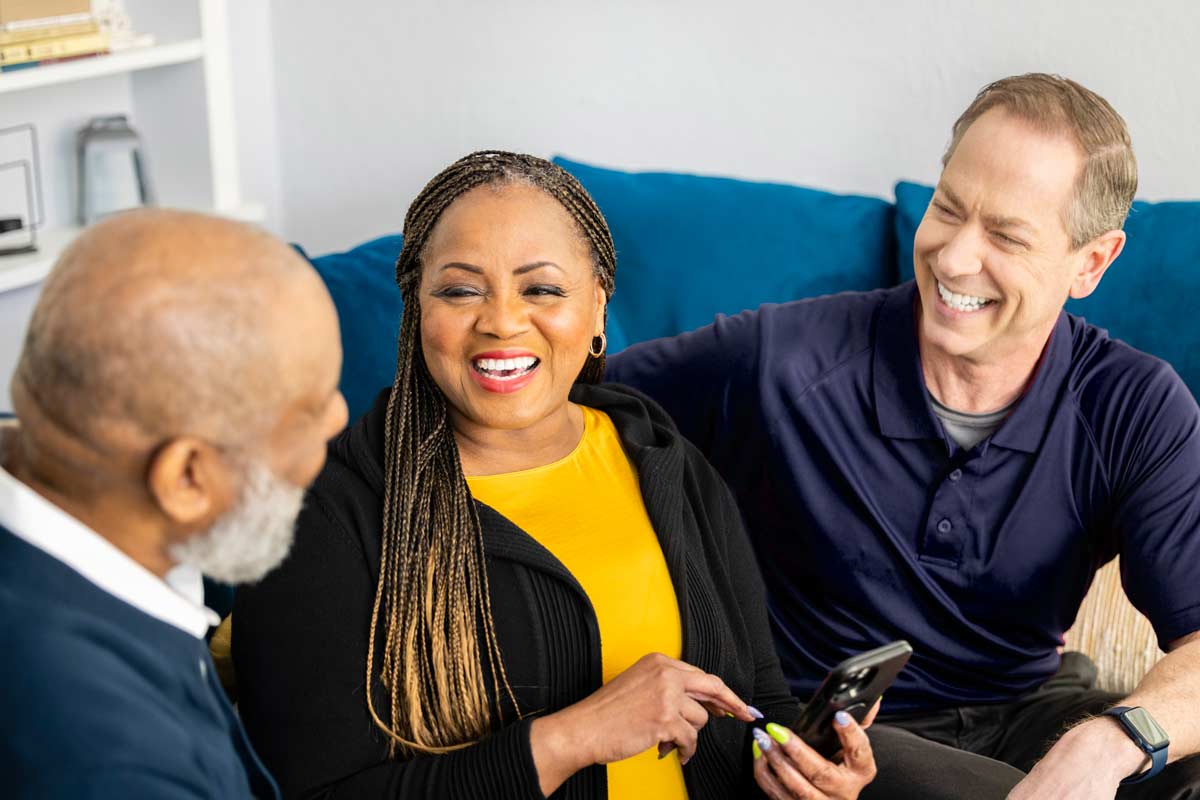 Aging man and daughter review mobile app with Care Professional